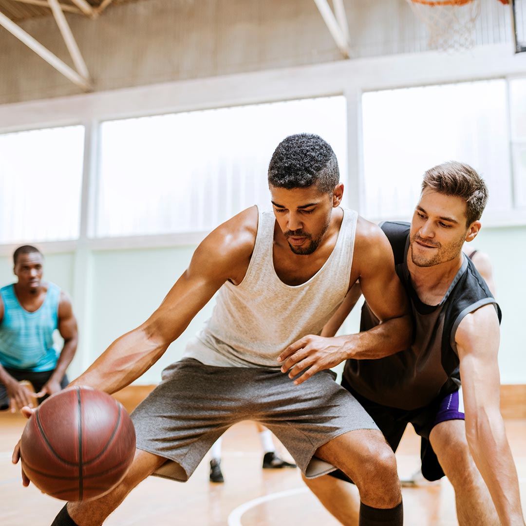 Two men playing basketball