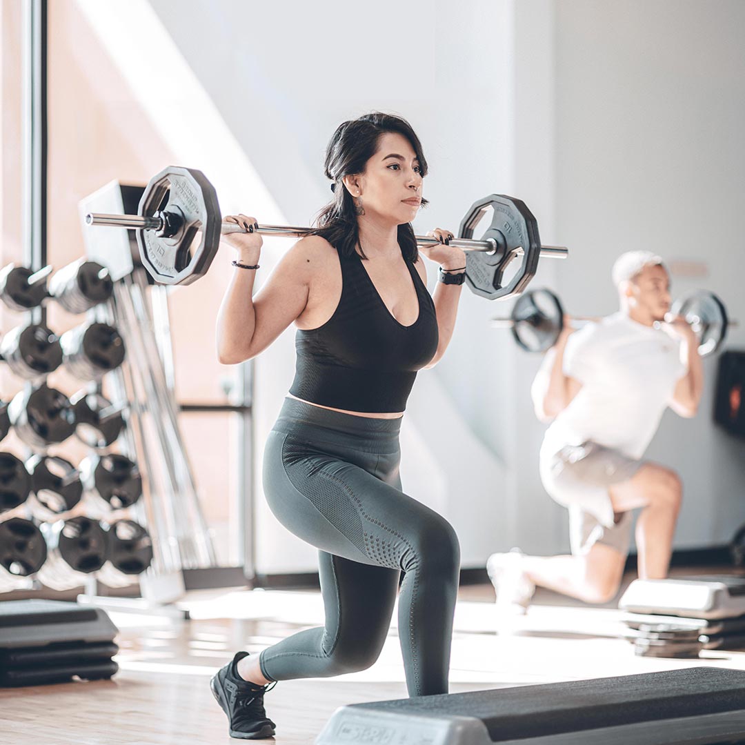 woman lifting dumbells in a strength class