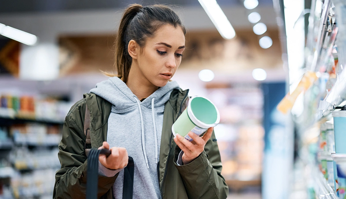Woman Reading a food label in a grocery store