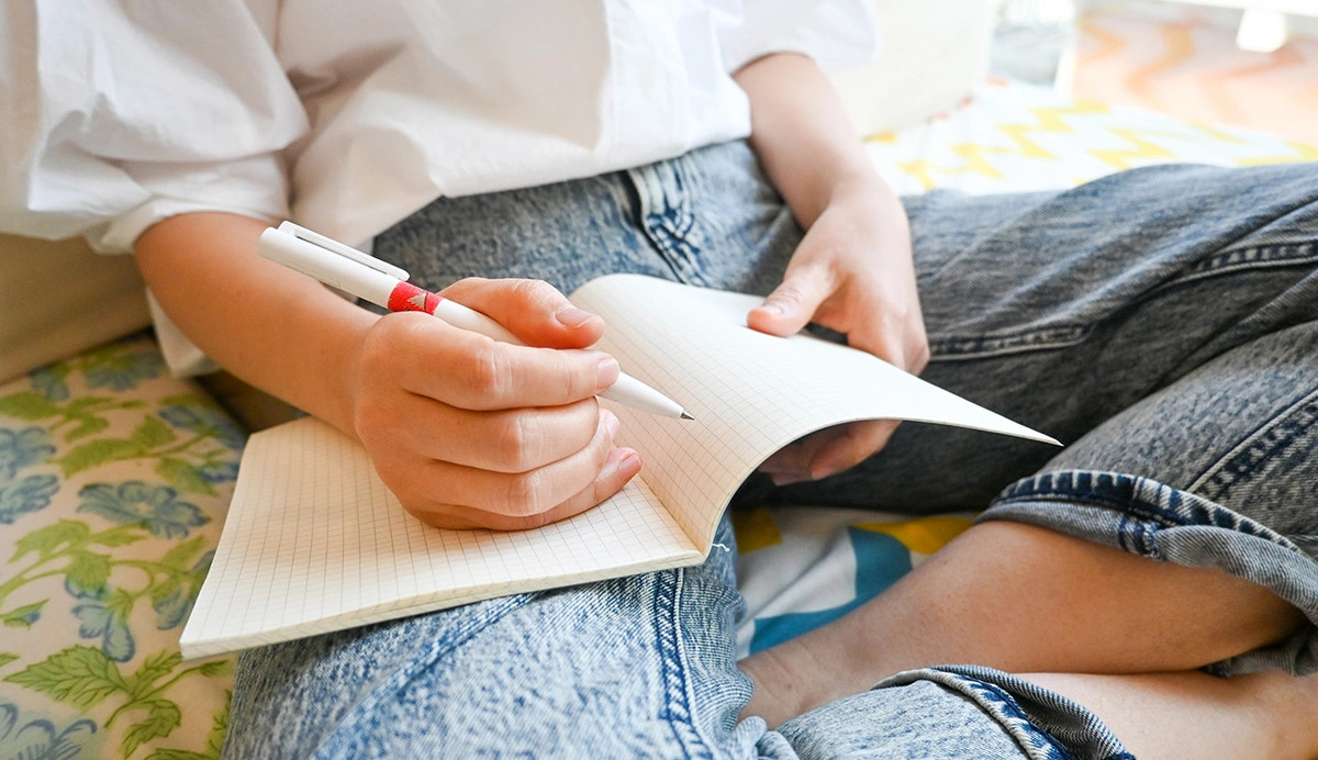 A woman writing in a notebook